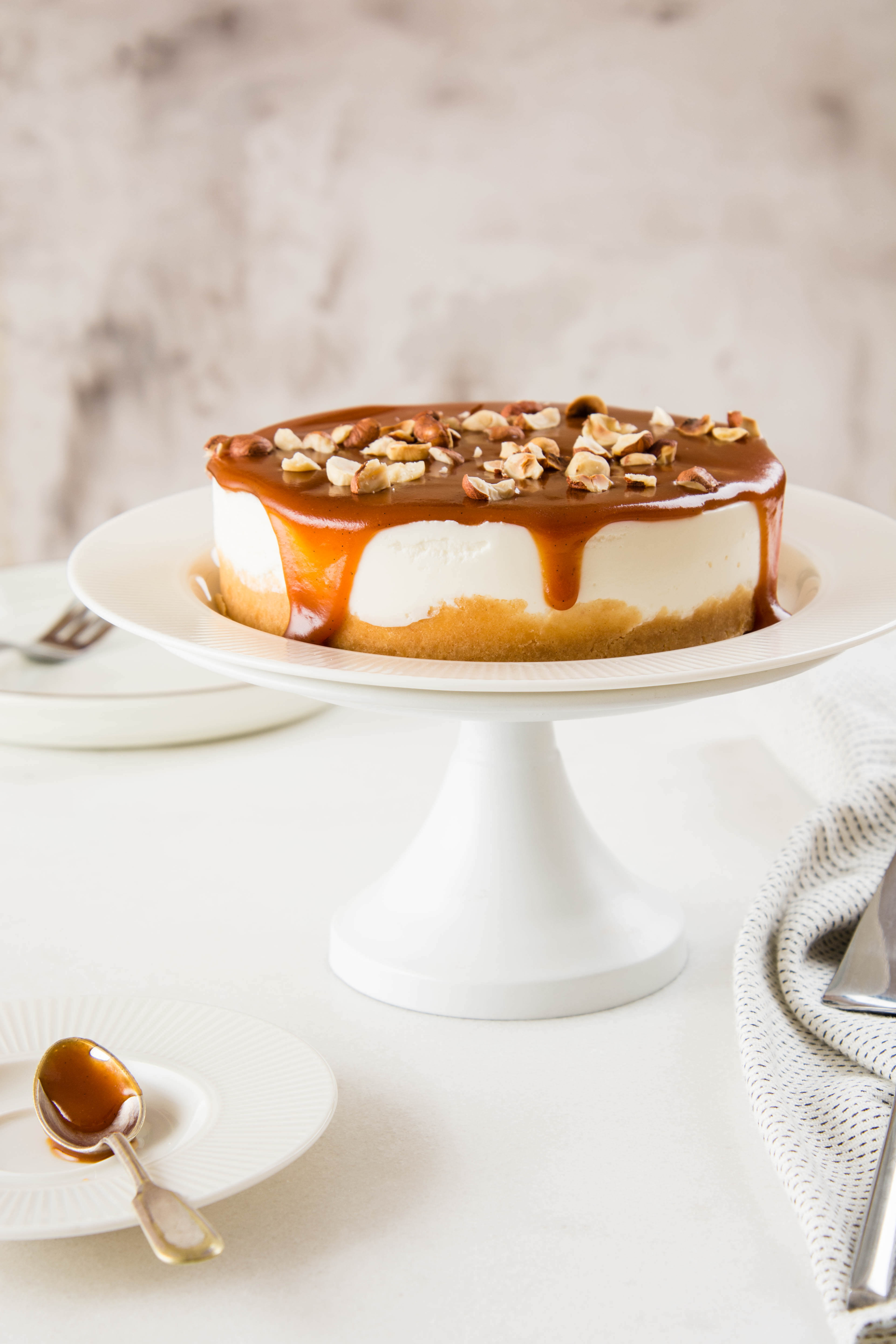 Homemade cheesecake with nuts and caramel sauce topping. Sweet cake at