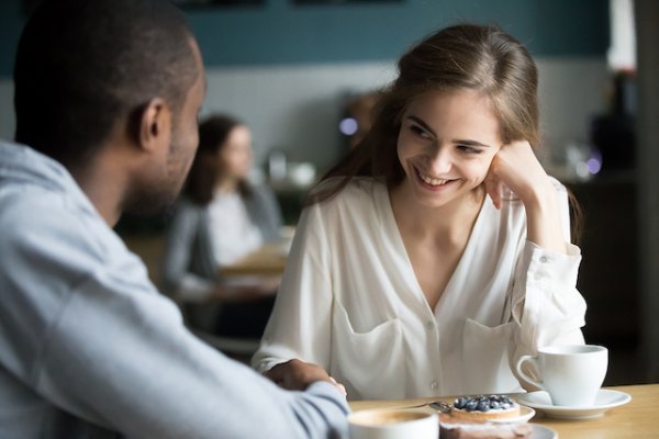 Happy Interracial Couple Flirting Talking Sitting At Cafe Table ...